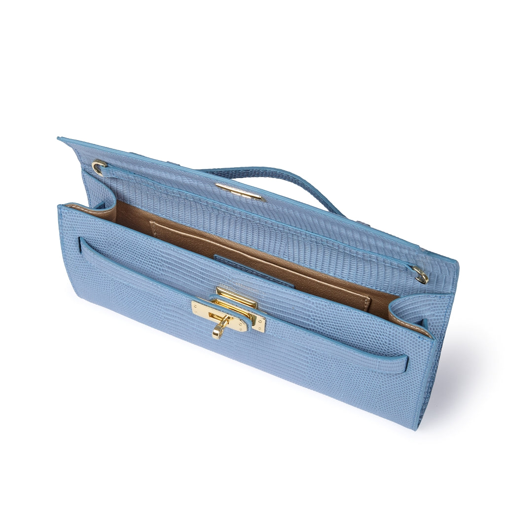 Jade Tejus clutch in leather featuring a secure closure, a retractable handle, and a detachable, adjustable shoulder strap.